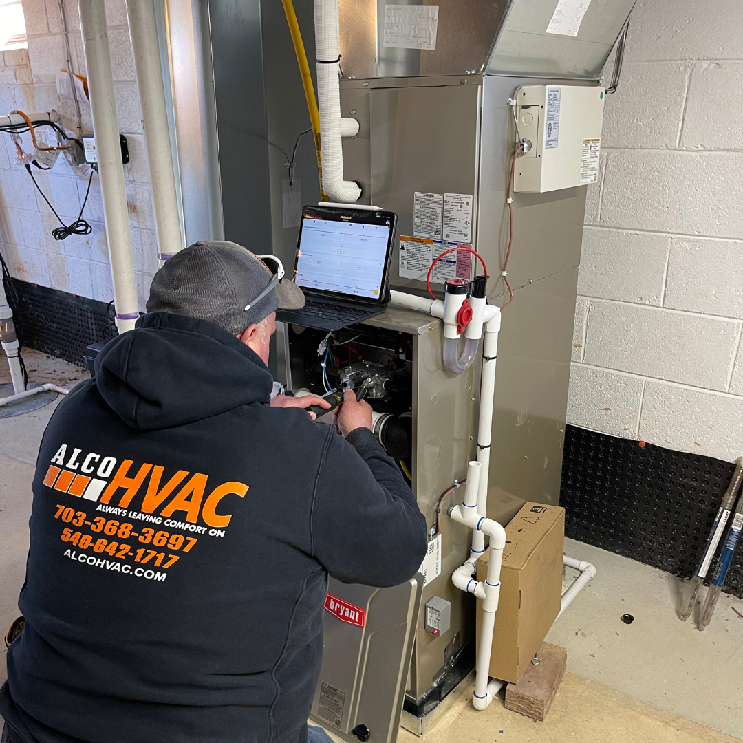 image of ALCO HVAC Plumbing & gas technician preforming furnace maintenance in Fredericksburg, VA
