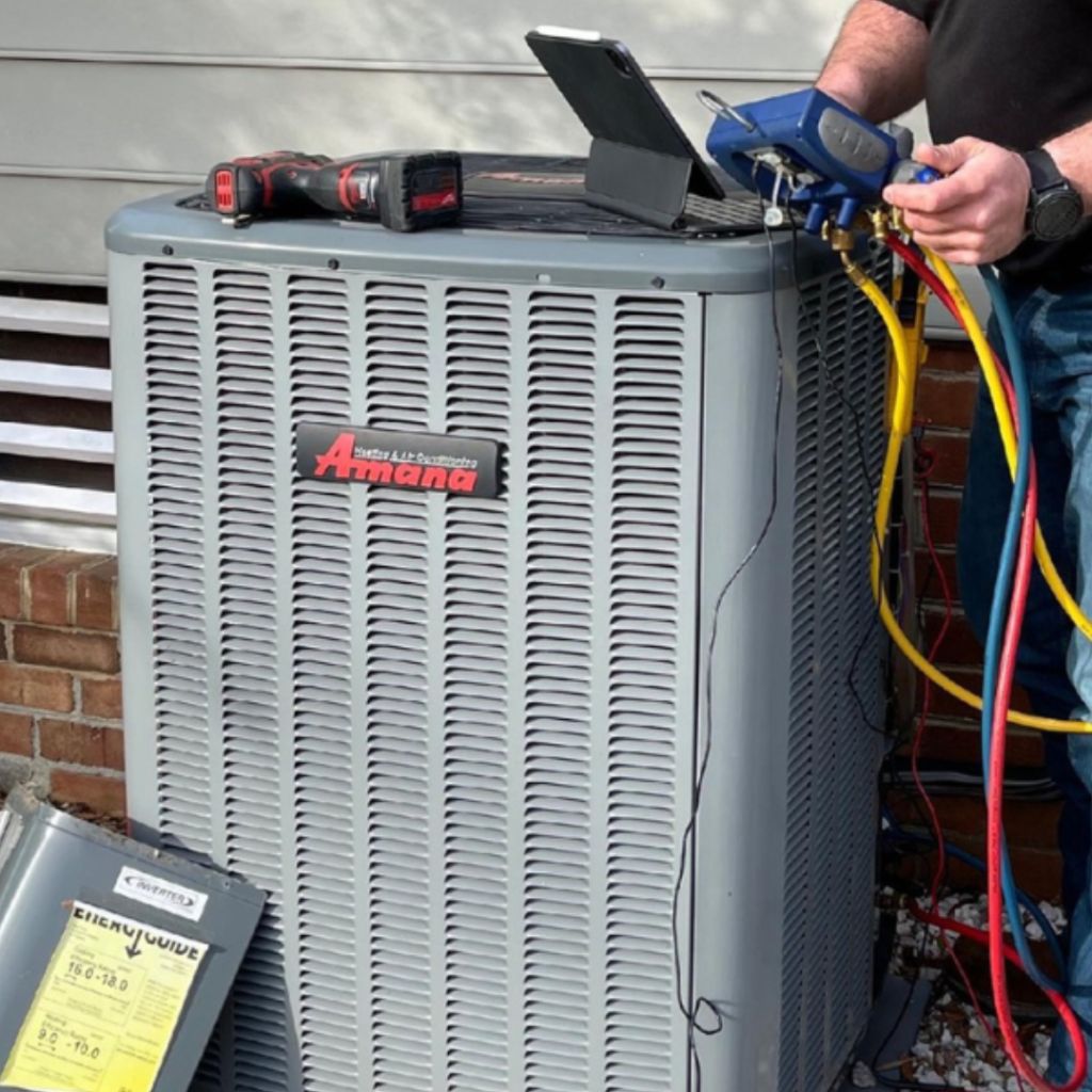 decorative image: ALCO Employee preforming spring time preventative maintenance on HVAC system